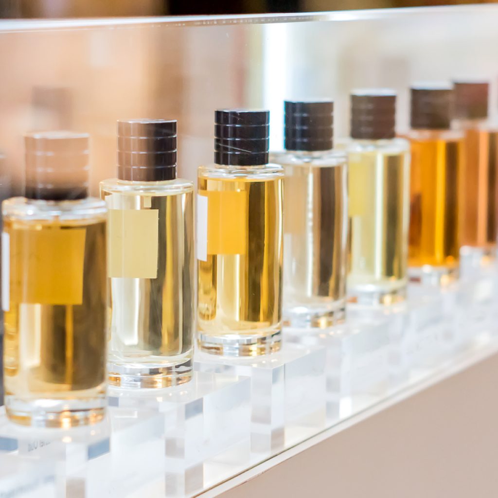 set of colorful perfume bottles in shop window.